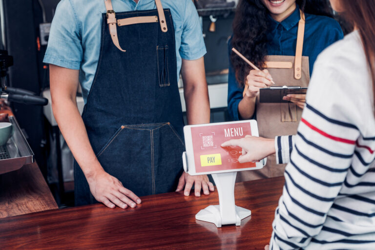 customer self service order drink menu with tablet screen at cafe counter bar,seller coffee shop accept payment by mobile.digital lifestyle concept