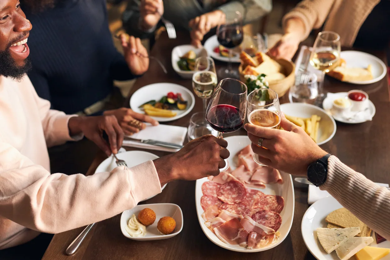 Friends toasting at dinner in restaurant