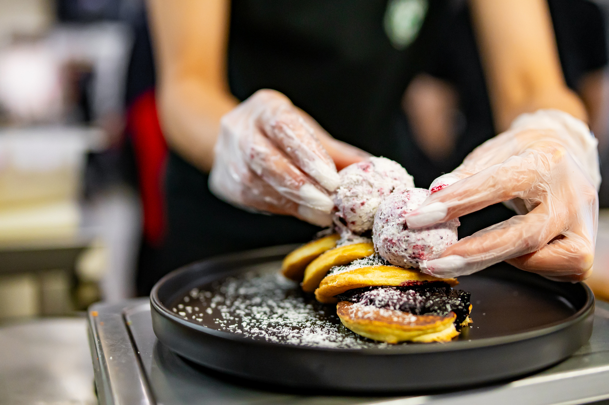 woman chef hand cooking pancakes with blueberry jam and ice cream on kitchen