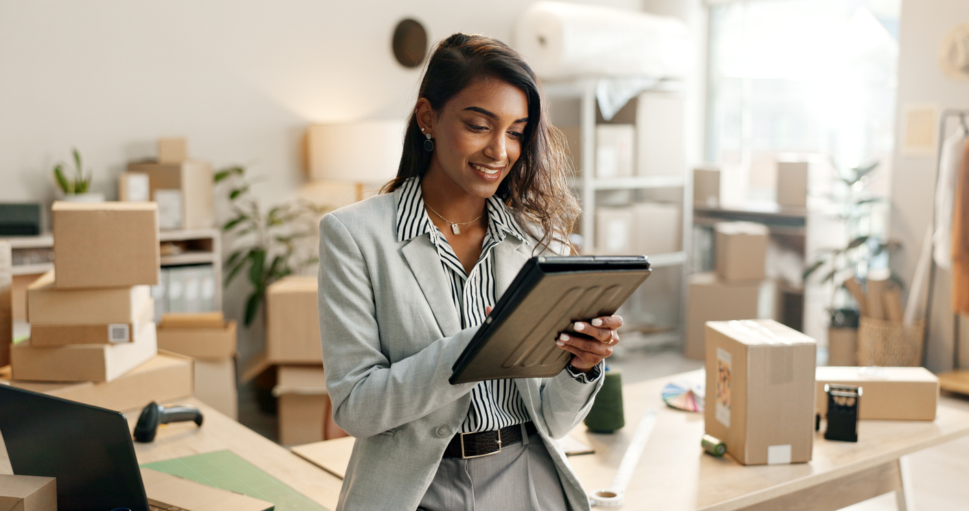 Small business, woman and tablet for e commerce, startup and inventory management of online shop, order or courier. Entrepreneur or Indian seller on digital technology for logistics, boxes or package. Price verification