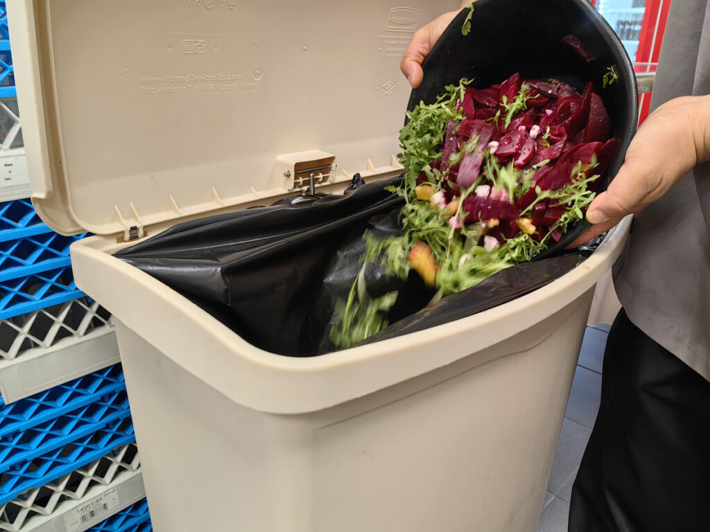 how to reduce food waste in restaurants - throwing out a salad with beets in it