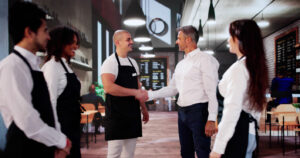Coffee Shop New Employee Handshake. Manager Welcome