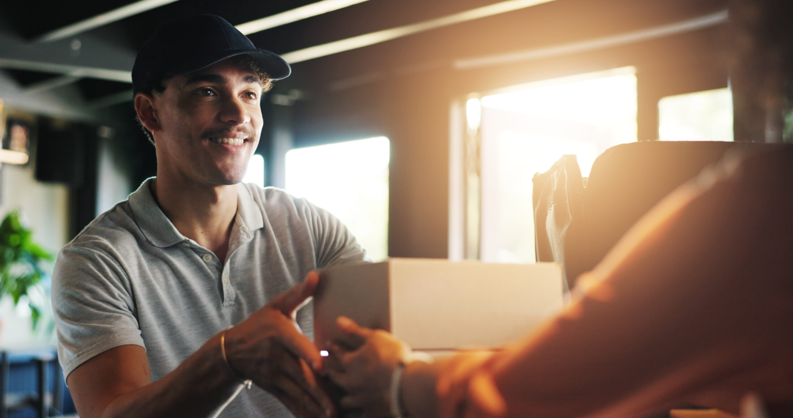 Man, waiter and restaurant for delivery with box for catering service, food or sale at diner. People, courier or barista giving order for collection, meal or small business at cafe or coffee shop